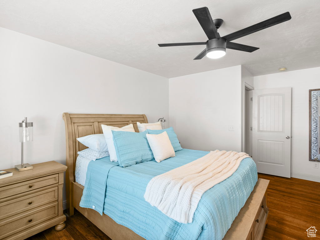 Bedroom with dark wood finished floors and ceiling fan