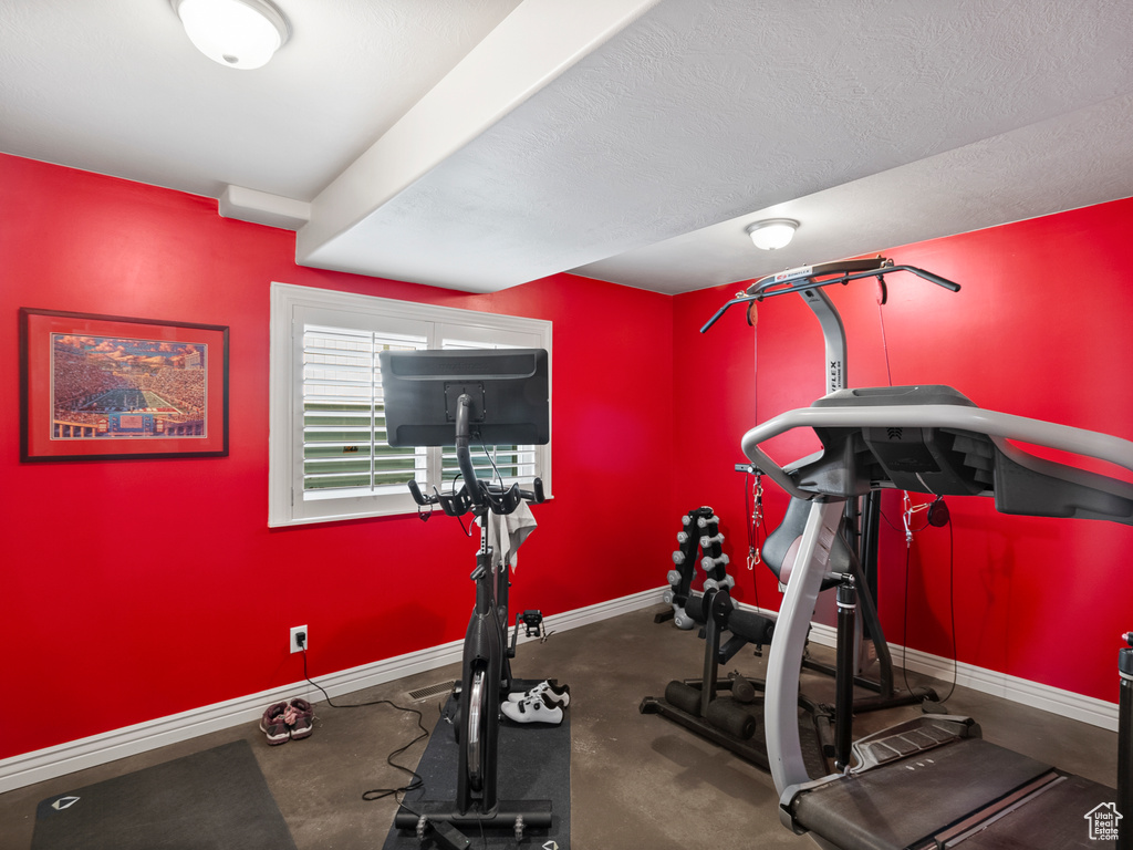 Workout area featuring baseboards