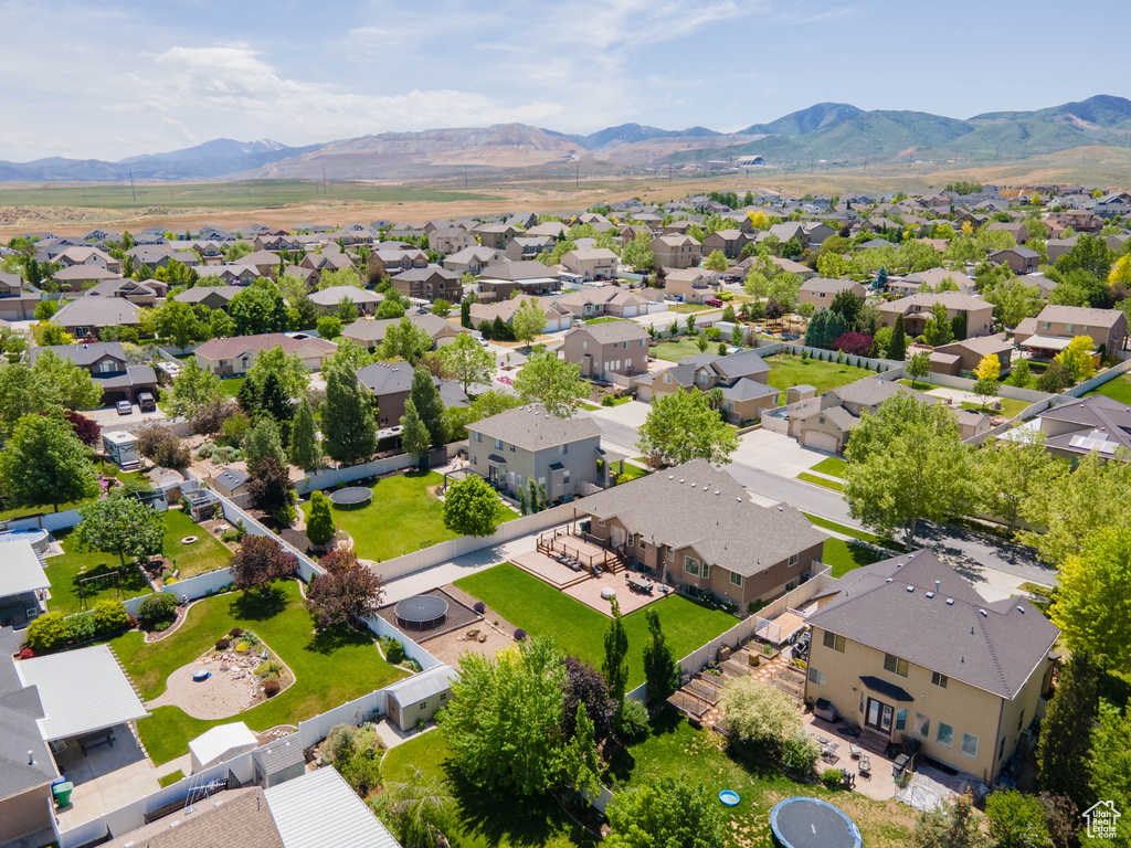 Aerial perspective of suburban area featuring a mountain backdrop