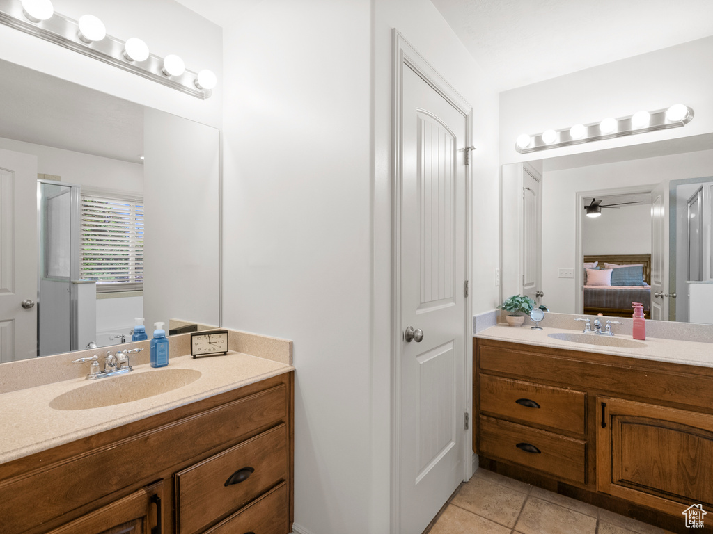 Full bath featuring connected bathroom, vanity, tile patterned floors, and ceiling fan
