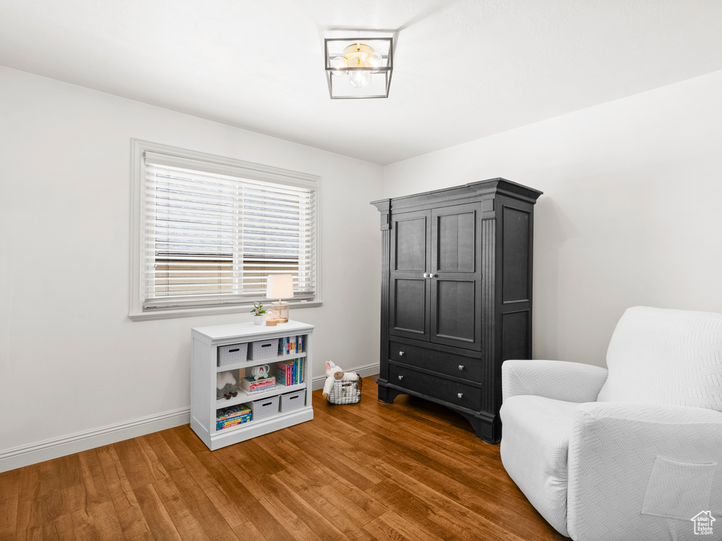 Living area featuring baseboards and wood finished floors