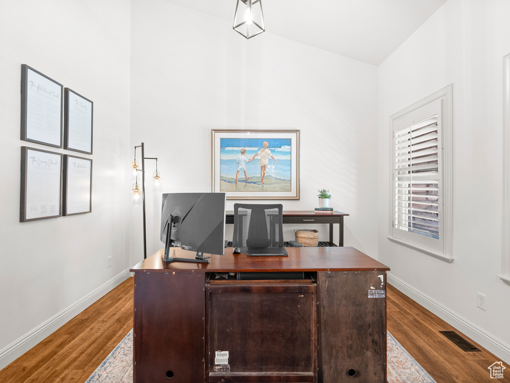 Office area featuring baseboards and wood finished floors