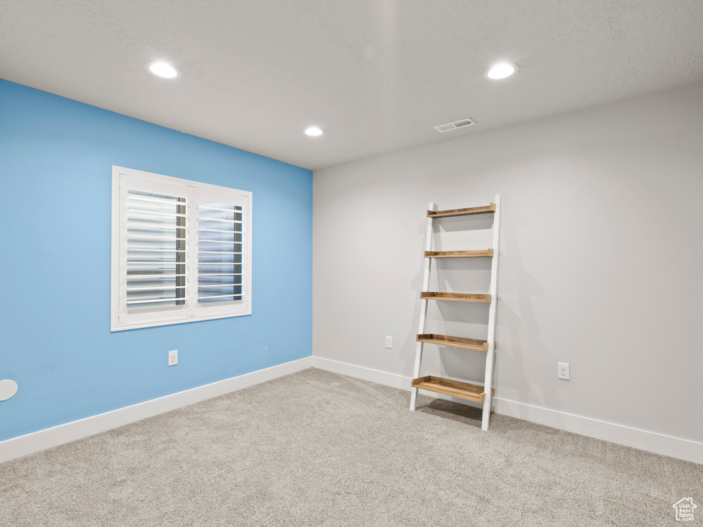 Empty room with carpet, recessed lighting, and baseboards