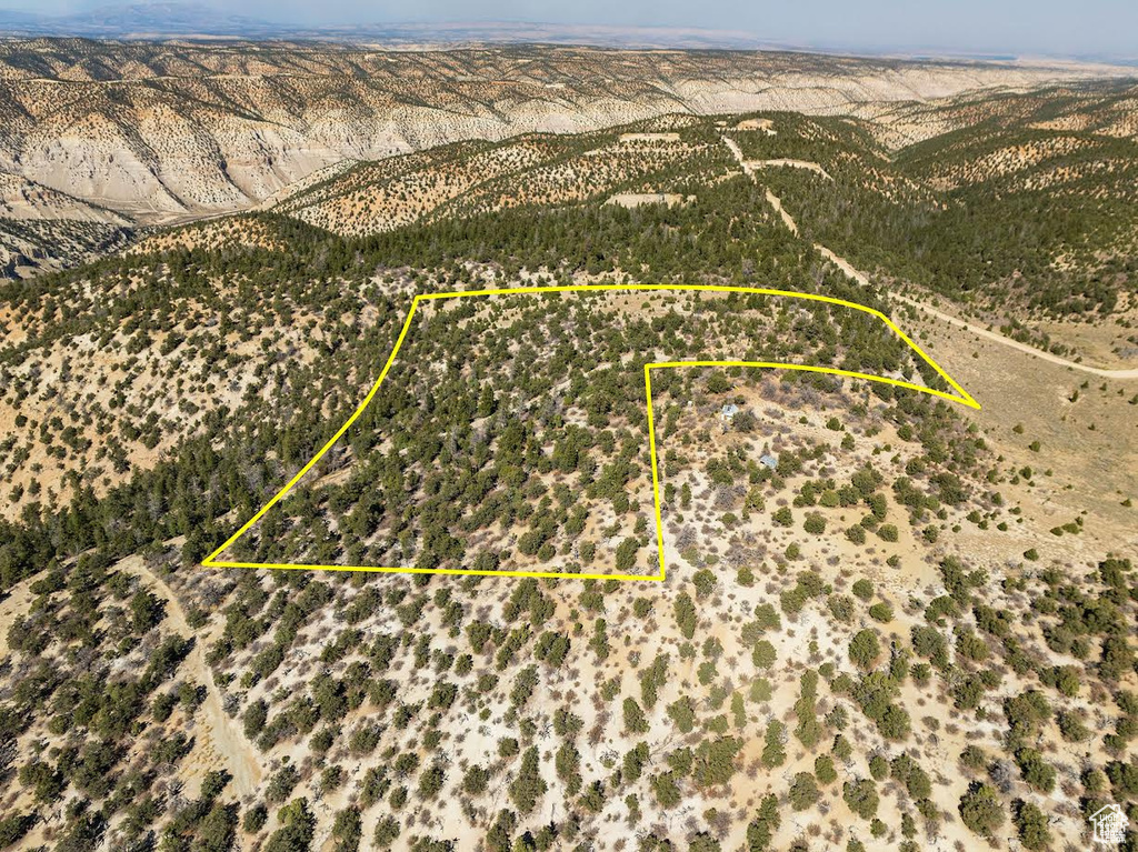 Aerial view of sparsely populated area with property parcel outlined