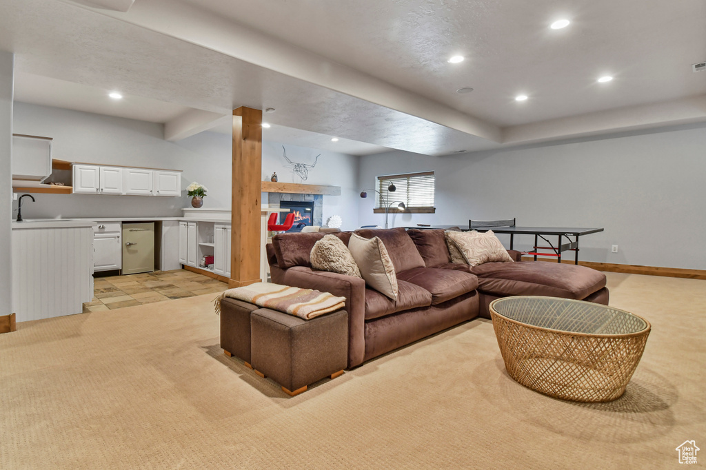 Living room with light colored carpet, recessed lighting, and baseboards
