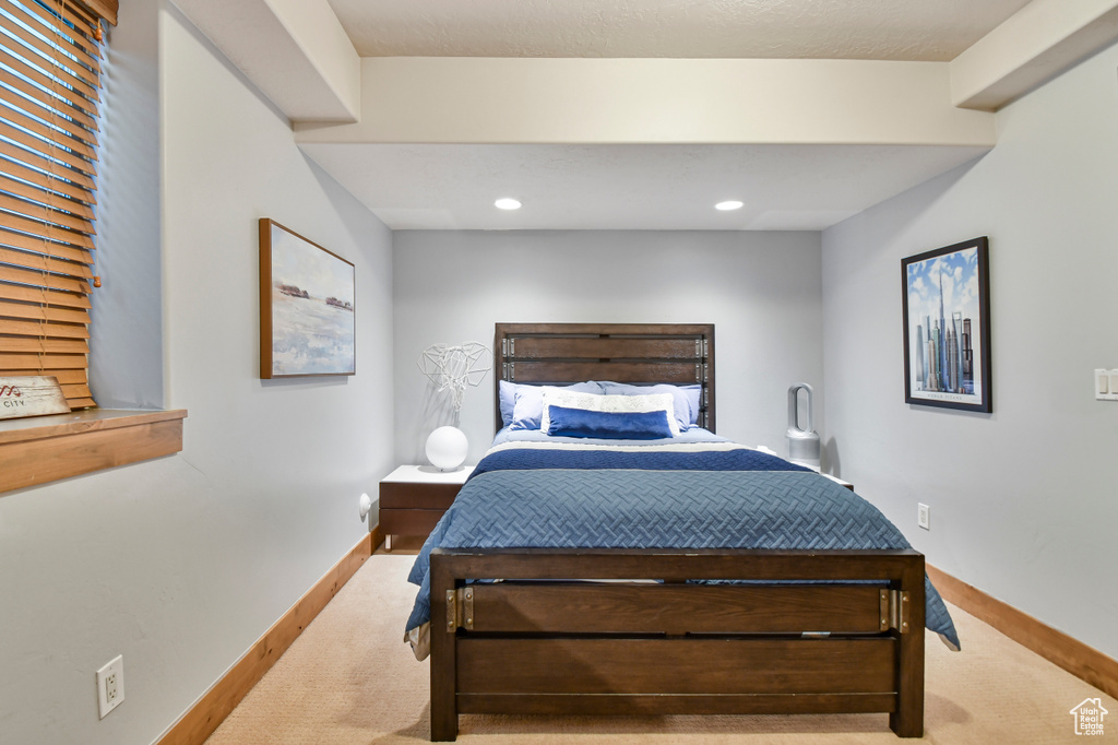 Carpeted bedroom with baseboards and recessed lighting