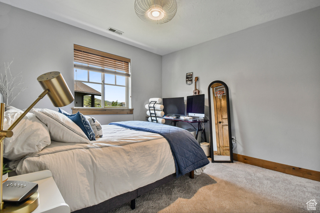 Carpeted bedroom with baseboards
