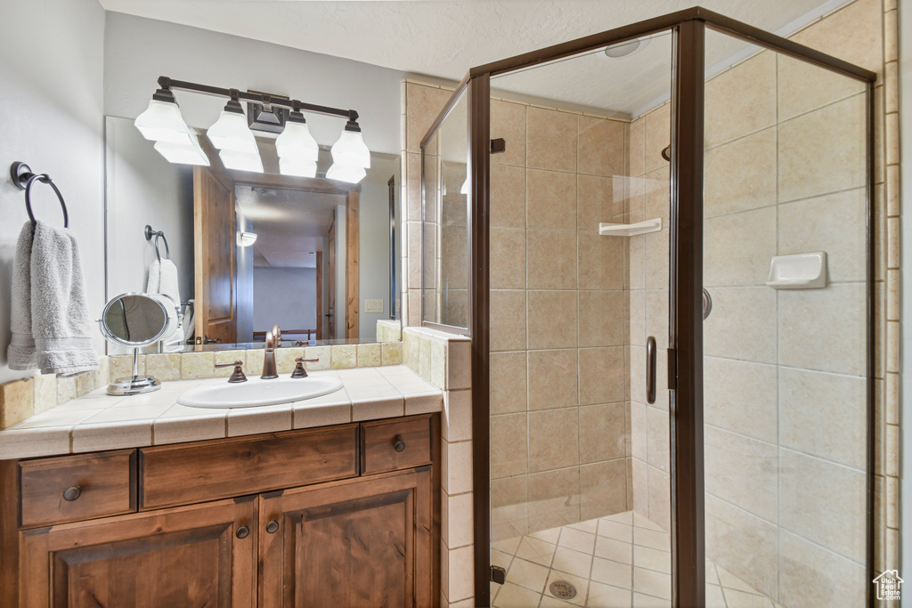Full bathroom with vanity and a shower stall