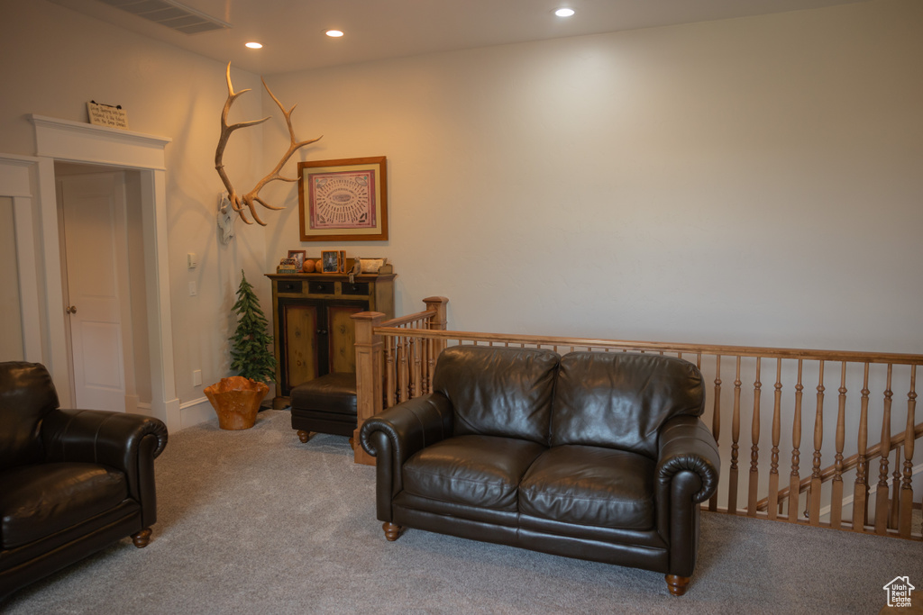 Living room with carpet flooring and recessed lighting