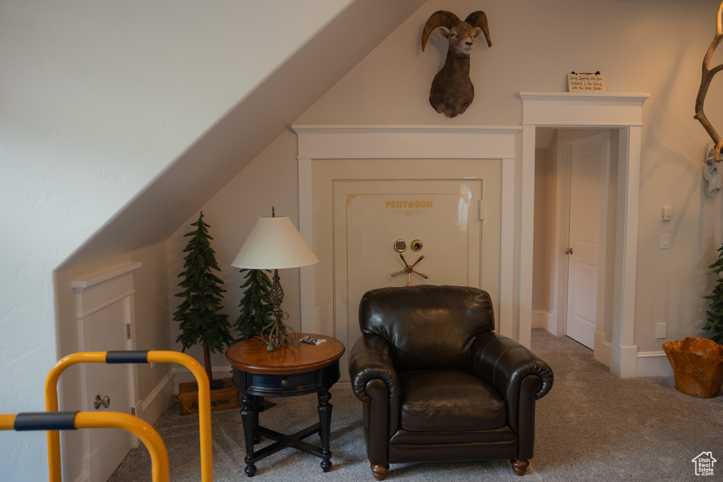 Sitting room featuring carpet and baseboards