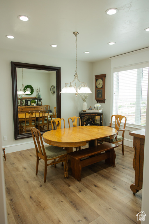 Dining space featuring light wood-style flooring, recessed lighting, a chandelier, and baseboards