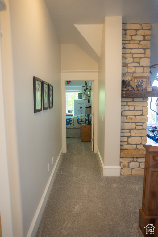 Corridor featuring carpet flooring and baseboards