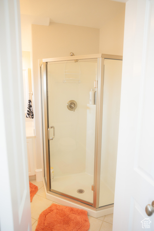 Bathroom featuring tile patterned floors and a stall shower