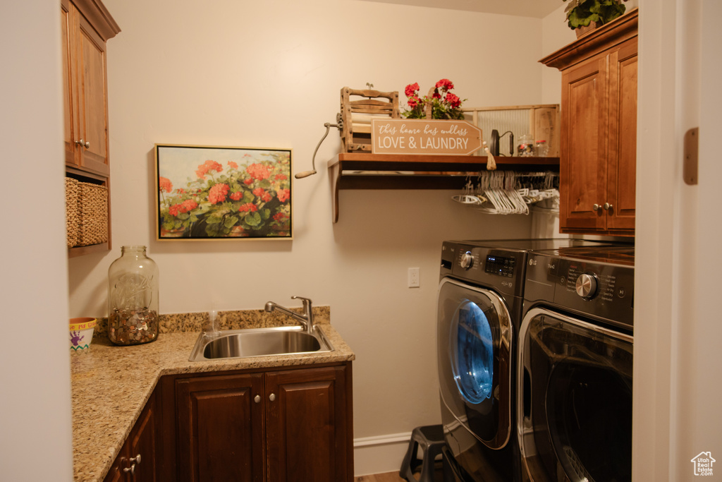 Laundry area with independent washer and dryer, cabinet space, and bar with sink