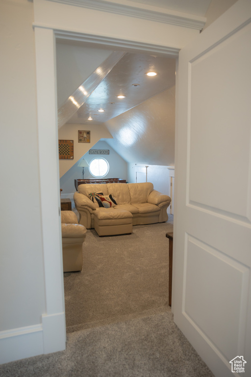 Living room featuring carpet and lofted ceiling
