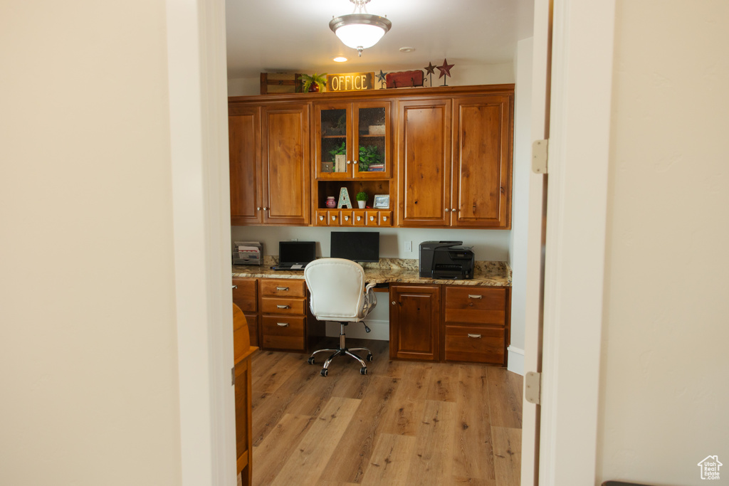 Office area featuring built in study area and light wood-type flooring