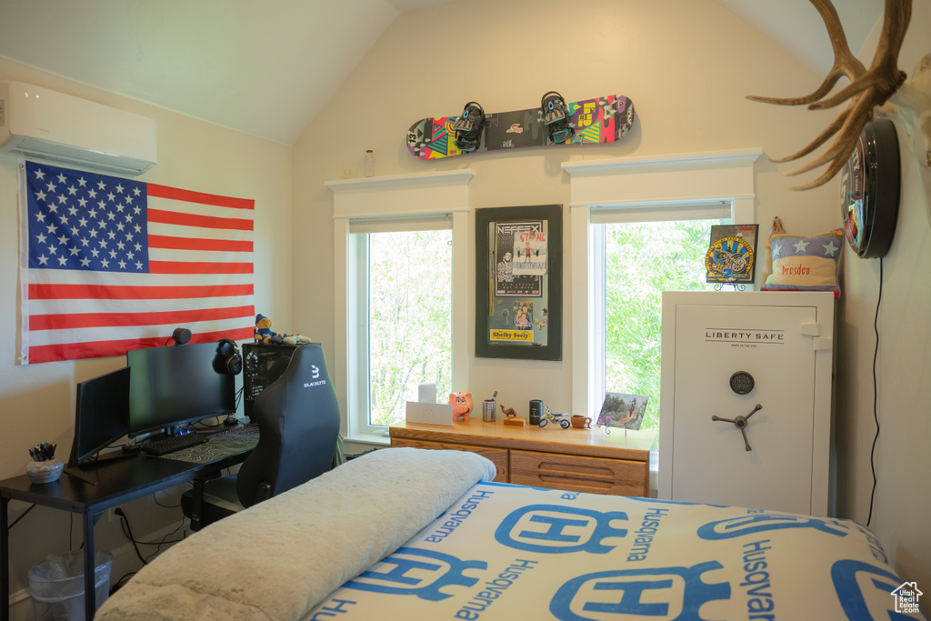 Bedroom featuring a wall mounted air conditioner and lofted ceiling