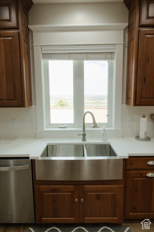 Kitchen featuring dishwasher, a sink, and light countertops