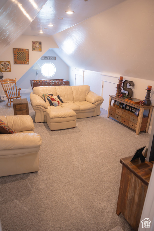 Living room with carpet floors and lofted ceiling
