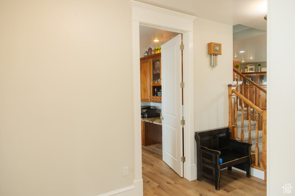 Hallway featuring light wood finished floors and baseboards