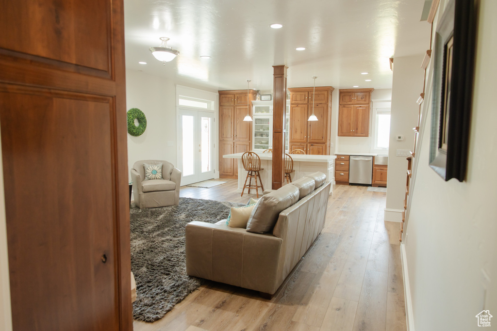 Living room featuring healthy amount of natural light, light wood-style flooring, and recessed lighting