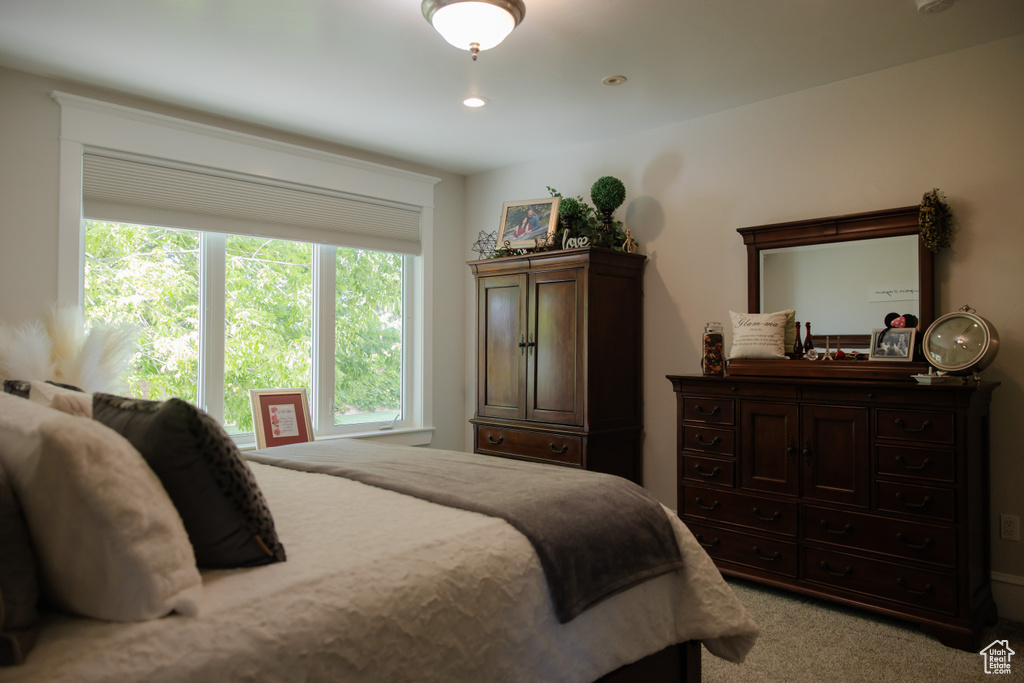 Bedroom with light carpet and recessed lighting