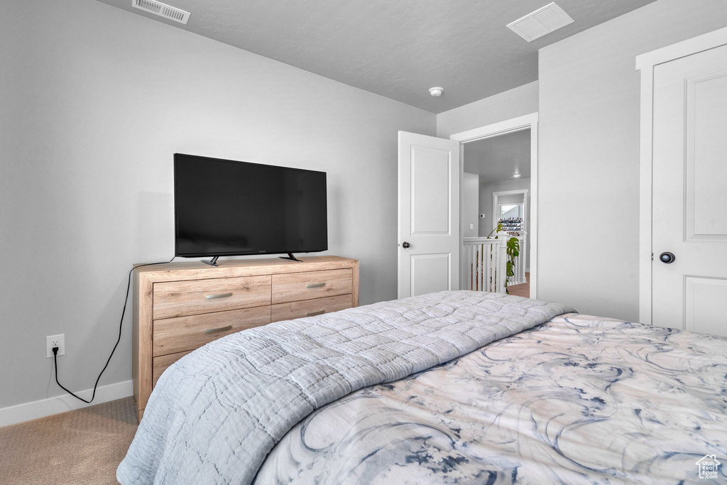 Carpeted bedroom with baseboards