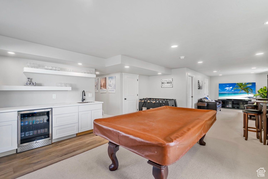 Game room featuring beverage cooler, bar with sink, billiards, recessed lighting, and light wood-style floors