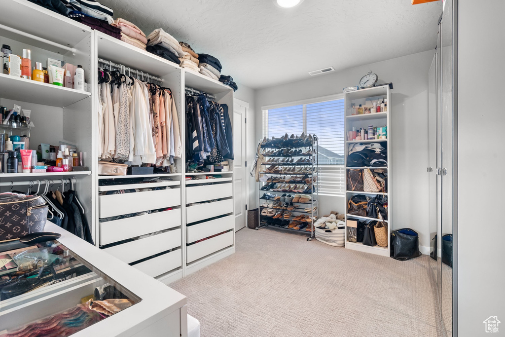 Spacious closet with carpet floors