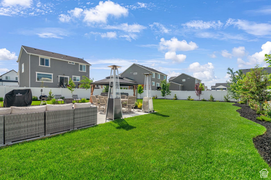 View of yard with outdoor lounge area, a gazebo, a patio, and a residential view