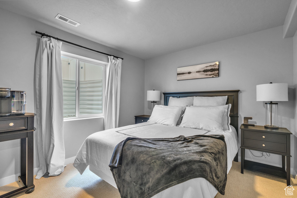 Carpeted bedroom featuring baseboards
