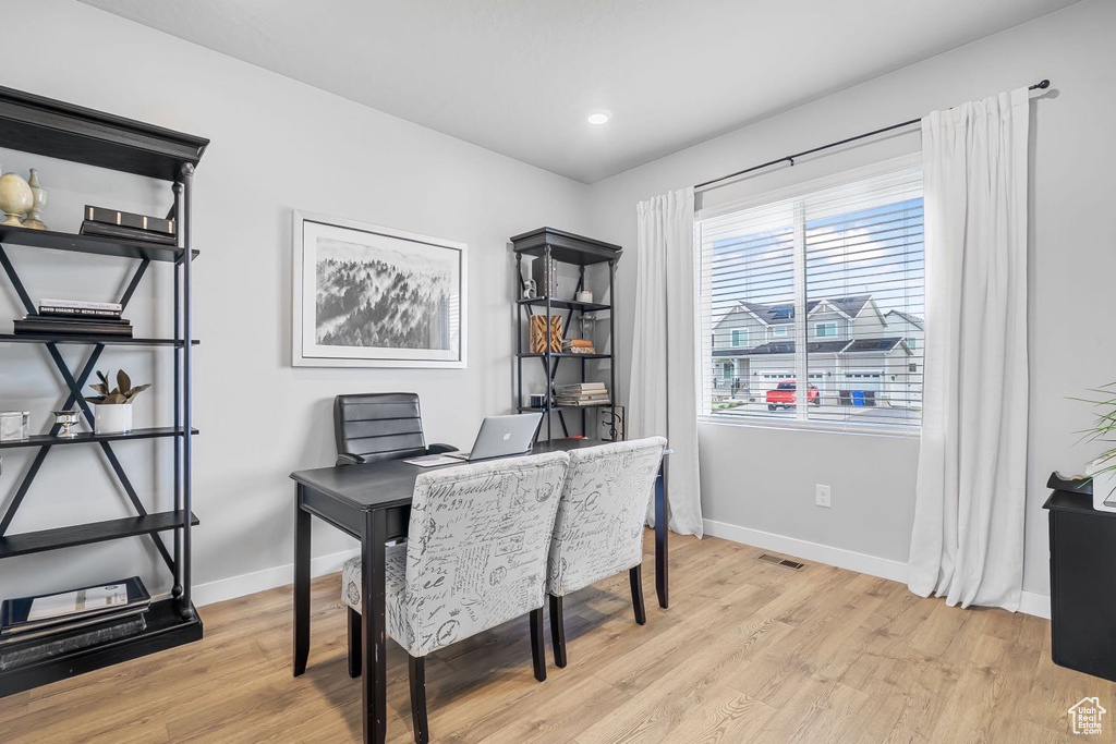 Office with light wood finished floors, baseboards, and recessed lighting