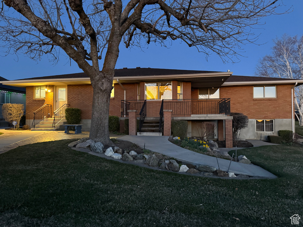 Single story home with brick siding and a front yard
