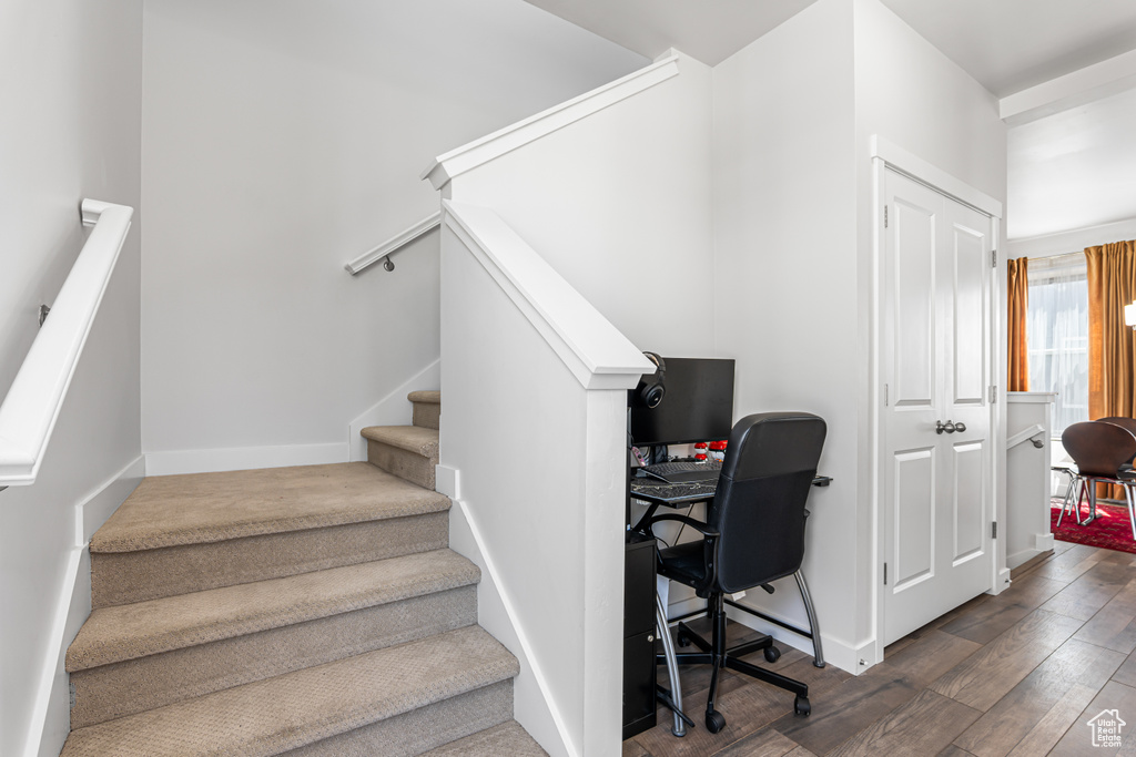 Stairs featuring wood finished floors and baseboards
