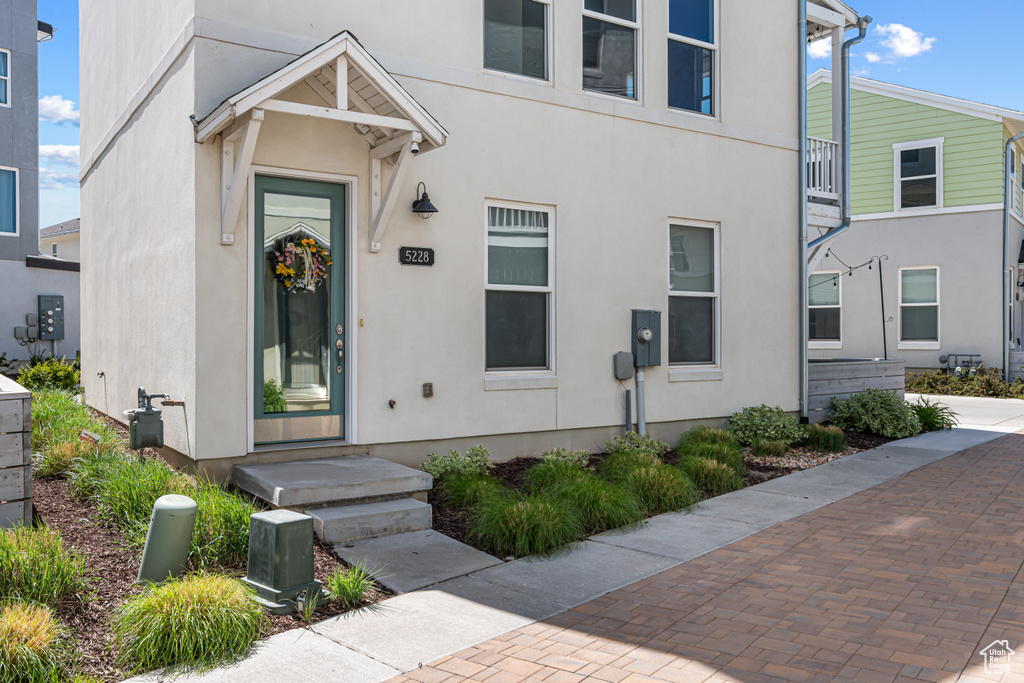 Doorway to property featuring stucco siding