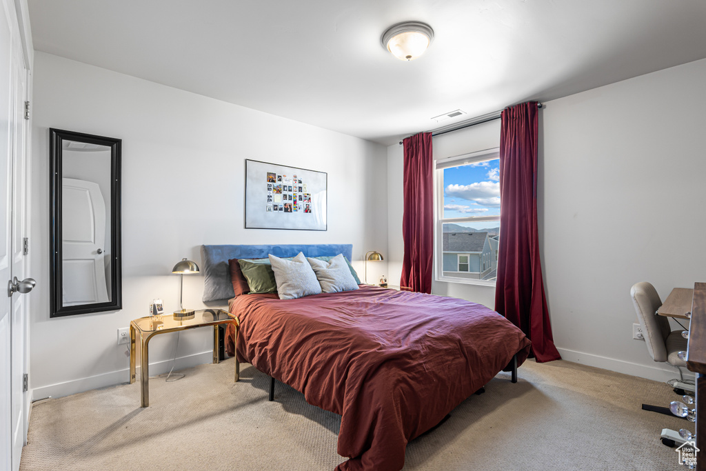Carpeted bedroom with baseboards