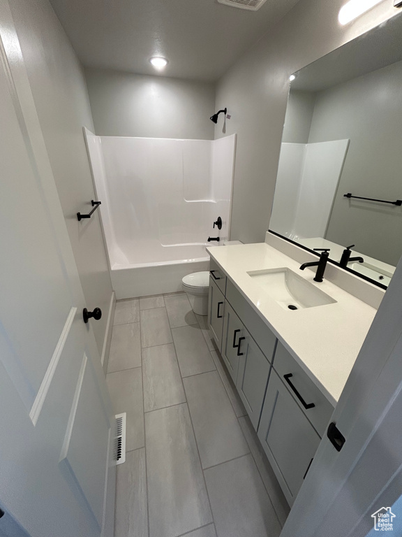 Bathroom featuring vanity, toilet, washtub / shower combination, tile patterned floors, and recessed lighting