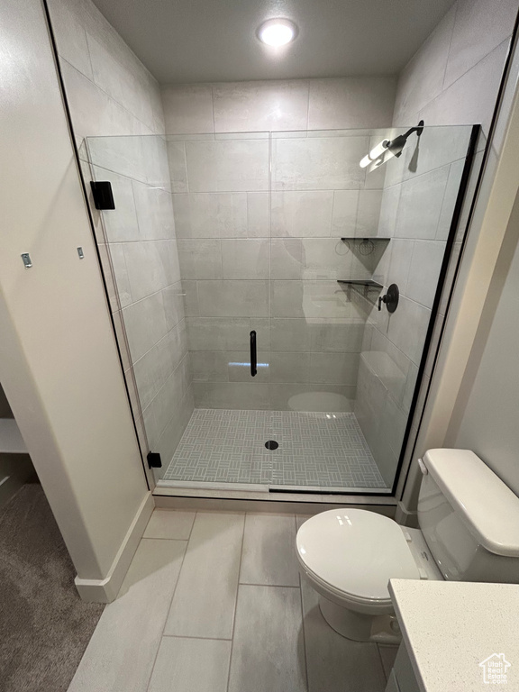 Bathroom with toilet, vanity, a stall shower, and recessed lighting