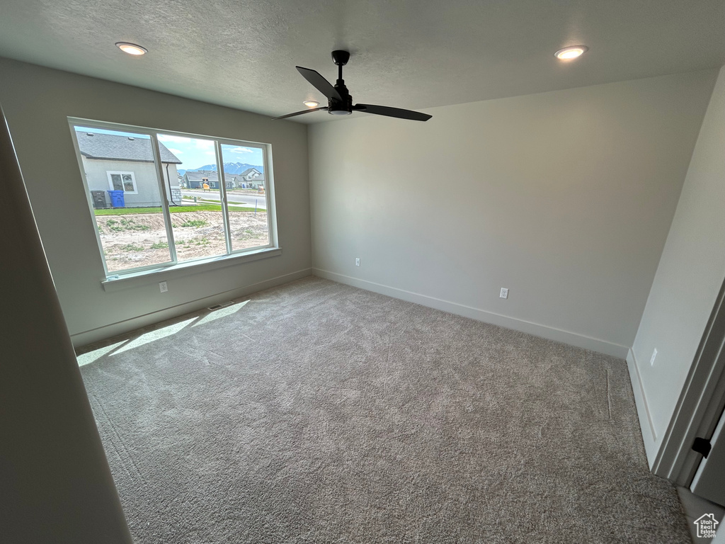 Unfurnished room featuring carpet floors, ceiling fan, baseboards, a textured ceiling, and recessed lighting