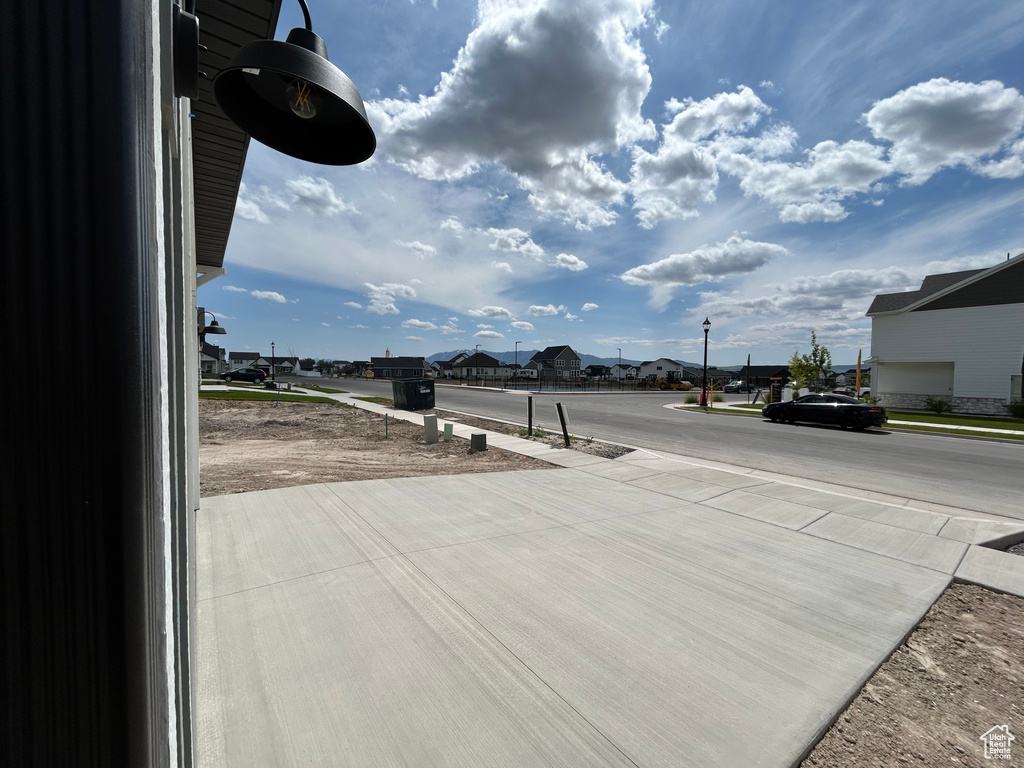 View of street with a residential view, sidewalks, and street lighting
