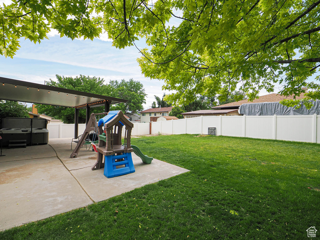 View of yard featuring a patio and a playground