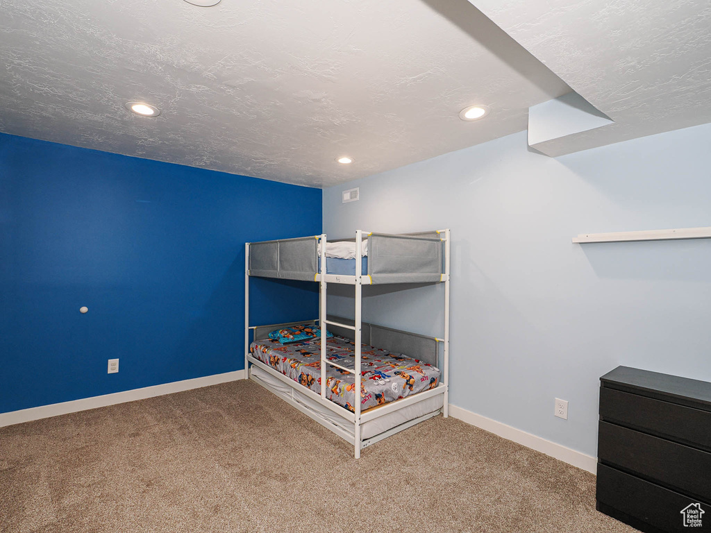 Unfurnished bedroom featuring carpet, baseboards, and recessed lighting