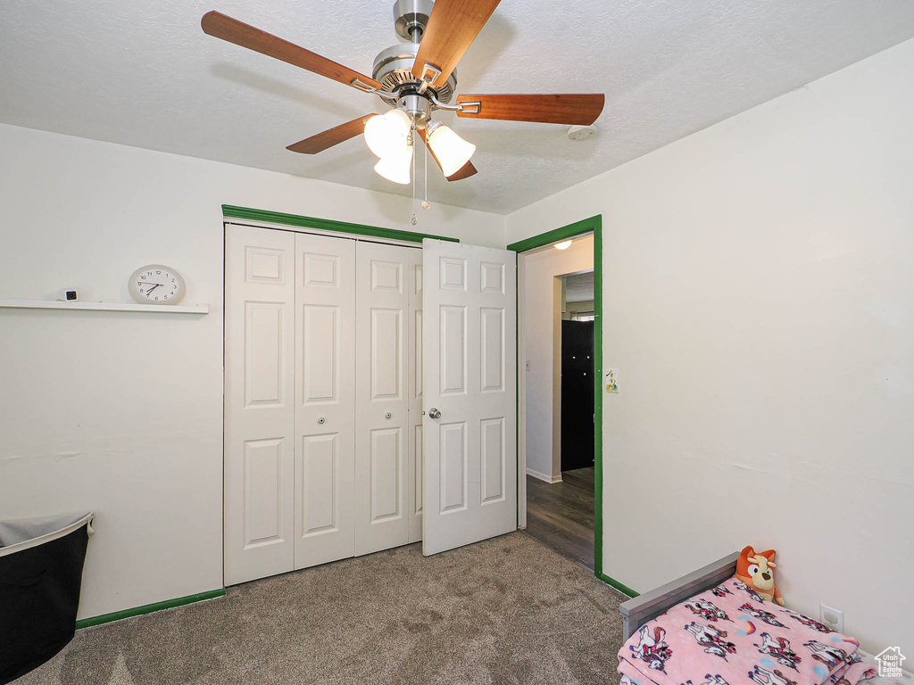 Bedroom featuring carpet, a closet, and a ceiling fan
