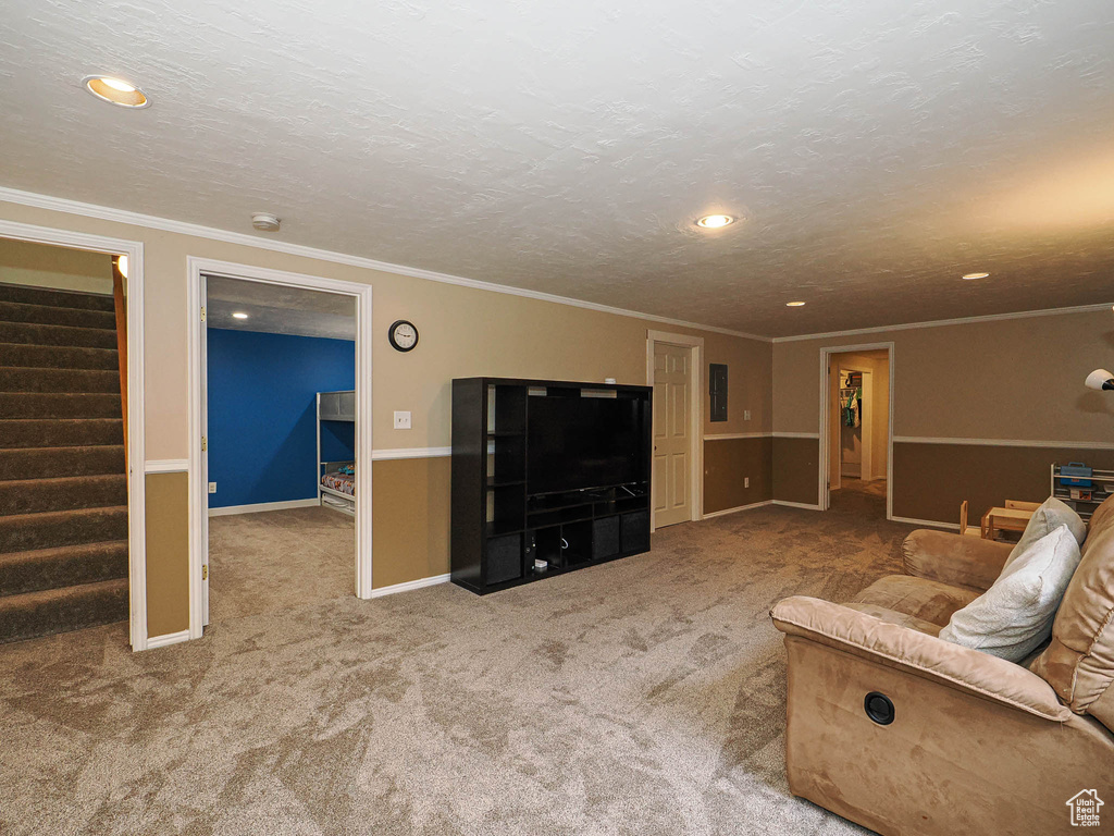 Carpeted living area featuring stairway, recessed lighting, ornamental molding, and baseboards