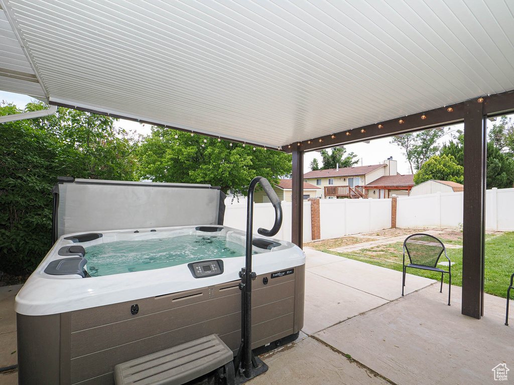 View of patio with a hot tub