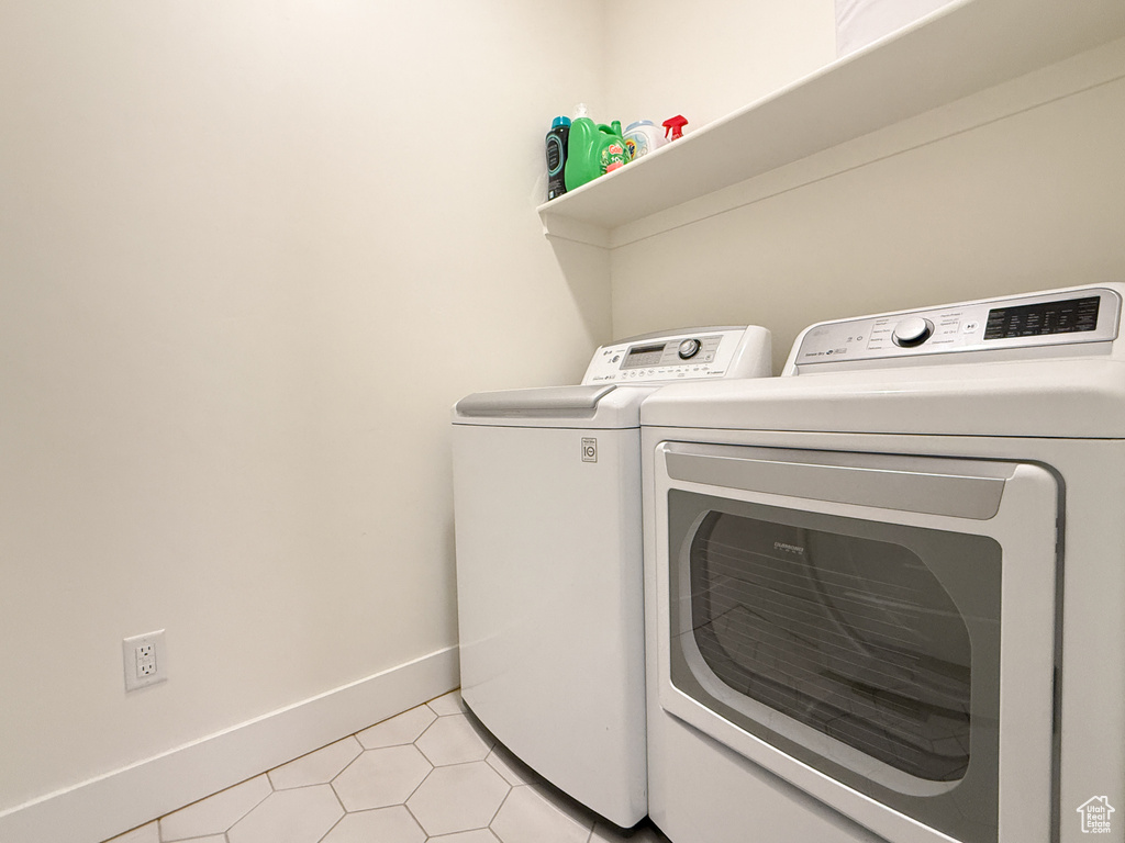 Laundry room featuring independent washer and dryer and baseboards