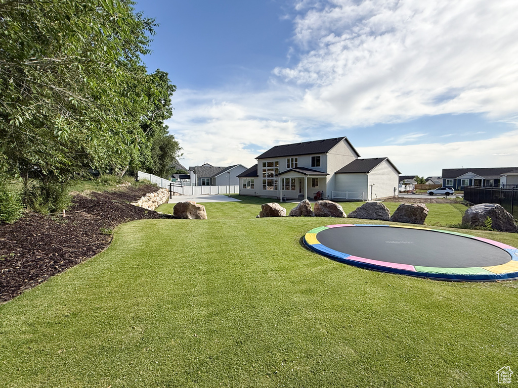 View of yard featuring a trampoline