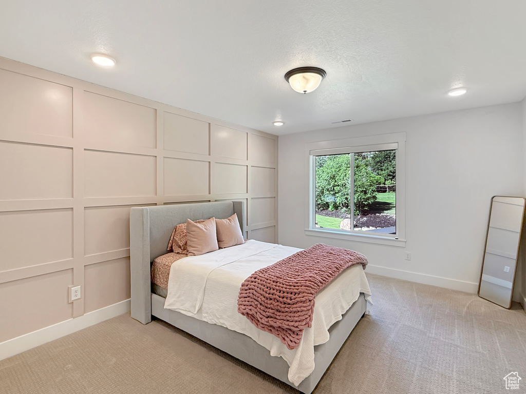 Bedroom with baseboards, light colored carpet, and recessed lighting
