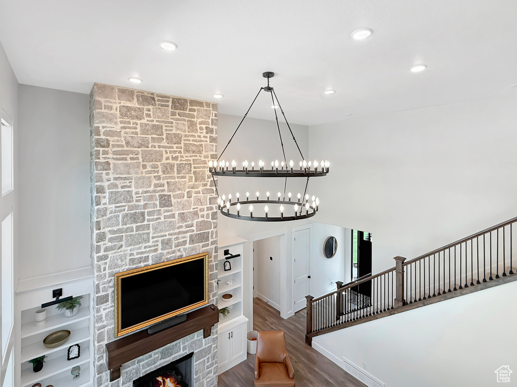 Unfurnished living room featuring wood finished floors, a chandelier, and recessed lighting