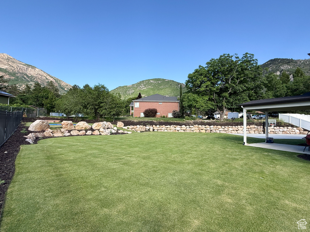 View of yard with a mountain view and a patio